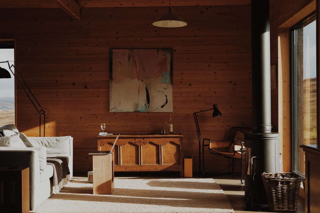 A wide angle shot of The Black Shed living room, showcasing the stylish interior furnishings, and luxurious self-catering offering.  